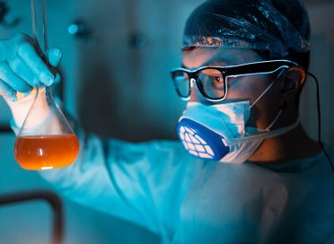 Young male researcher carrying out scientific researcher, working at laboratory.